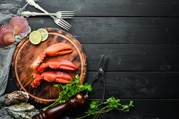 Lobster claws Seafood on a black background Top view Free copy space