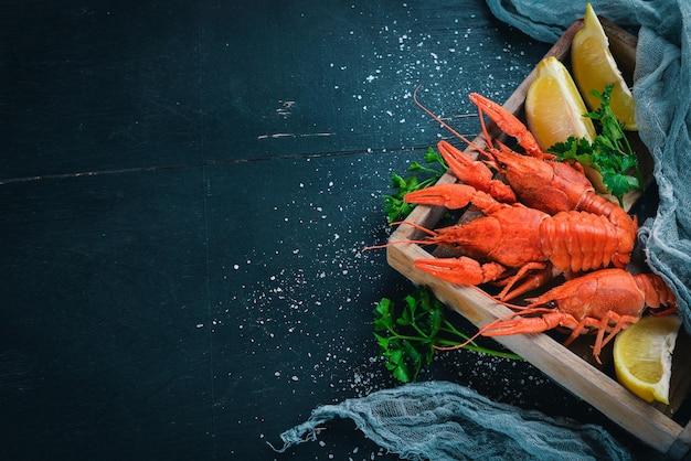 Lobster and fresh vegetables Seafood On a wooden background Top view Free space for your text