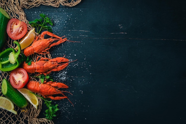 Lobster and fresh vegetables Seafood On a wooden background Top view Free space for your text