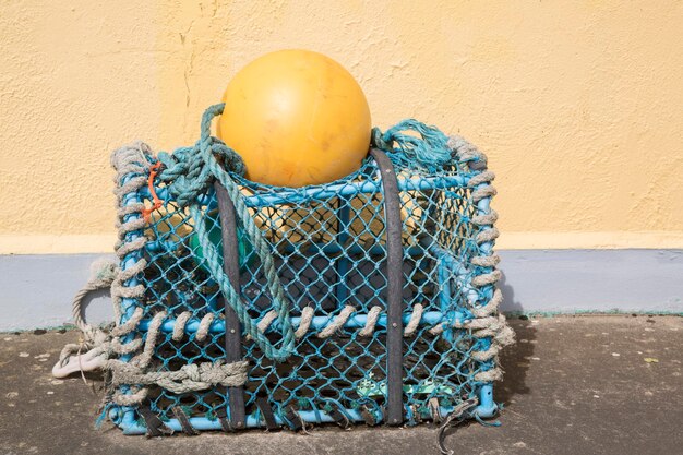 Lobster Trap against Yellow Wall