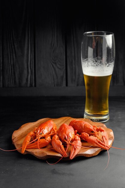 Lobster with beer on black background