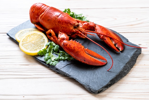 lobster with vegetable and lemon on black slate plate