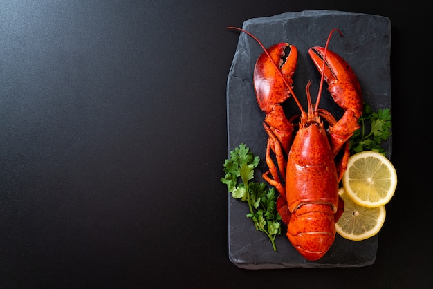 lobster with vegetable and lemon on black slate plate