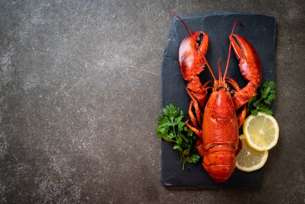 lobster with vegetable and lemon on black slate plate