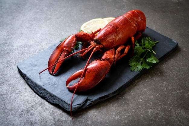 lobster with vegetable and lemon on black slate plate