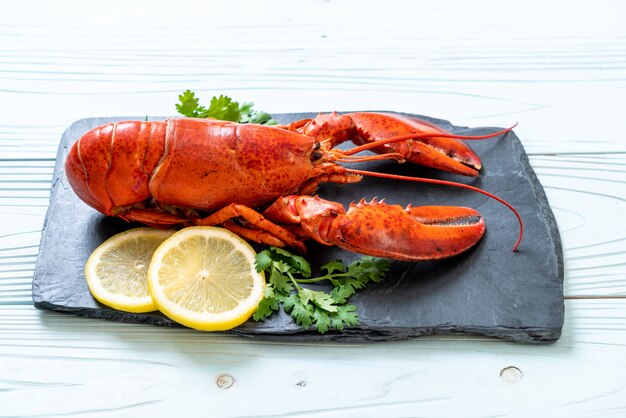 lobster with vegetable and lemon on black slate plate