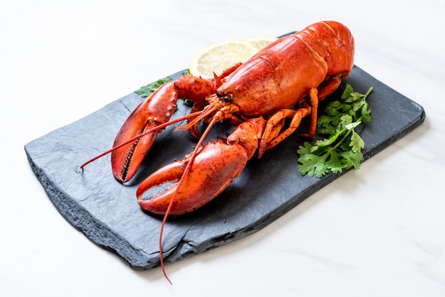 lobster with vegetable and lemon on black slate plate