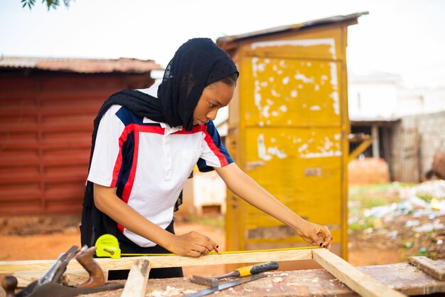 Local African carpenter at work smiling