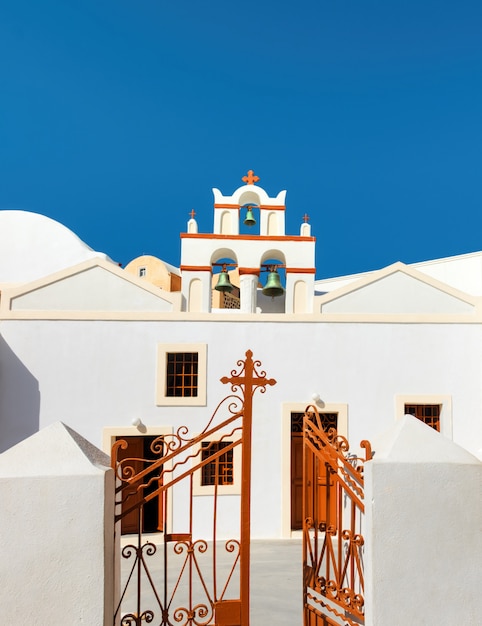 Local church with bell tower in oia, santorini, greece