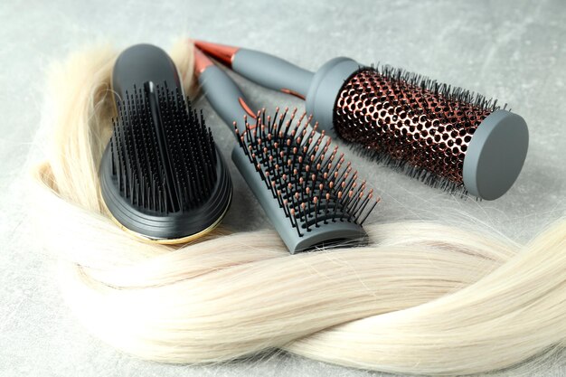 A lock of blonde female hair with hairbrushes