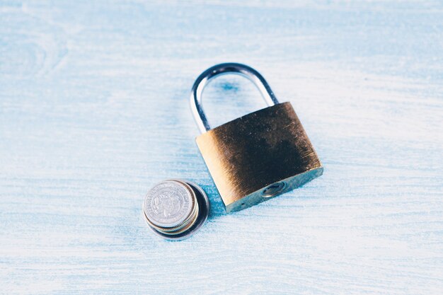 Lock and coins on the table