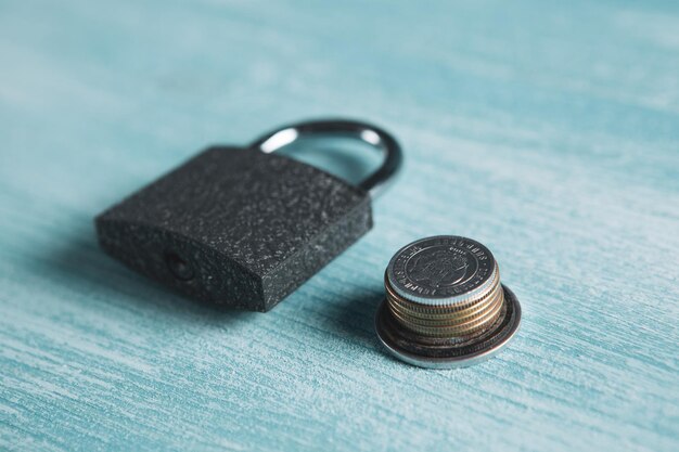 Lock and coins on the table