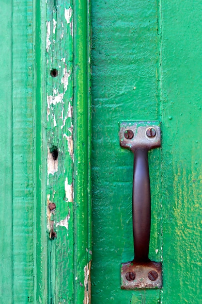 Photo lock and knob in closed green antique door