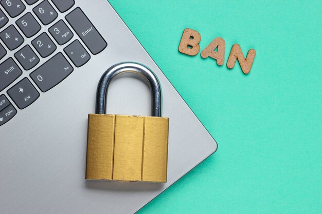 Lock on a laptop keyboard with the word ban