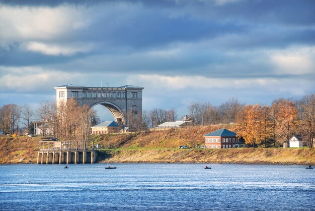 A lock for ships on the river in Uglich and fishermen's boats in the rays of the autumn sun