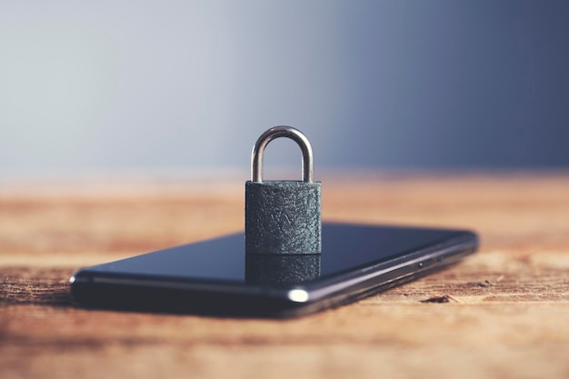 Lock on smart phone on wooden table