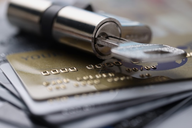 Lock with key rests on plastic credit cards