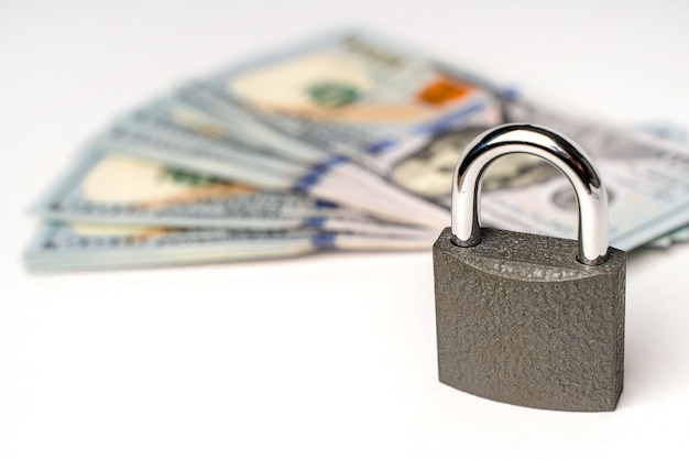 Photo locked lock on banknotes as a concept of financial security of deposits and money storage