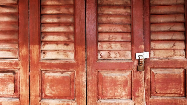 Locked Old Vintage Wooden Door with Ventilation Grille