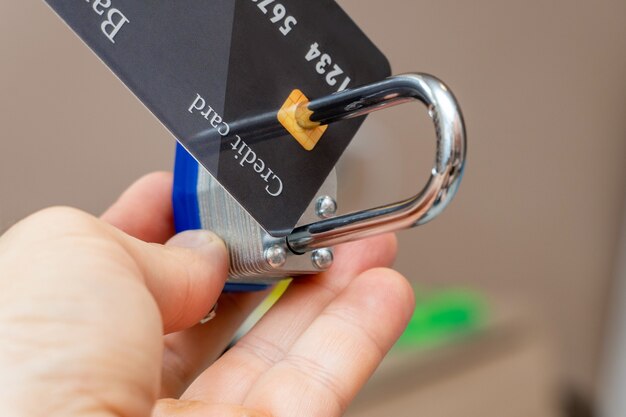 Photo locked with metal padlock plastic credit card close up