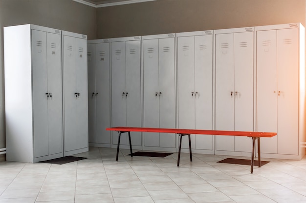 Locker room in the gym with metal drawers and benches