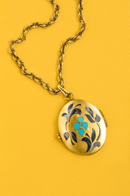 Locket necklace on yellow