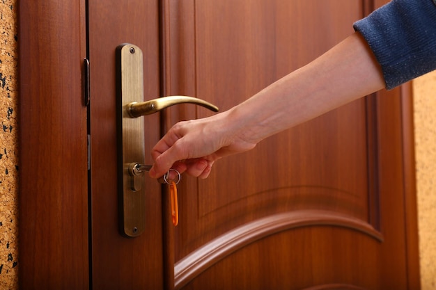 Locking up or unlocking door with key in hand