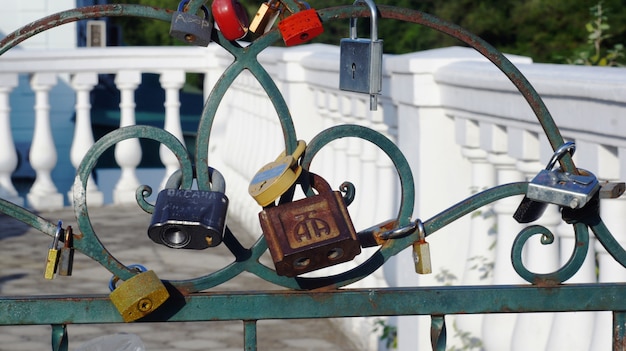 Locks on a metal fence as symbols of love.