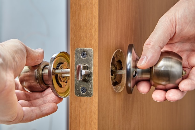 Locksmith showing parts of an interior door handle, including knob, rose, bolt, latch assembly, shank and lock button.