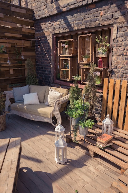 Loft garden design of veranda. wooden decorations. green plants