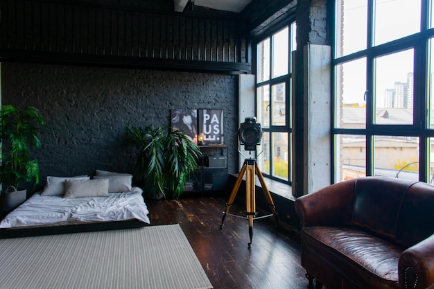 loft-style apartment interior, black walls, minimalism, white bed.