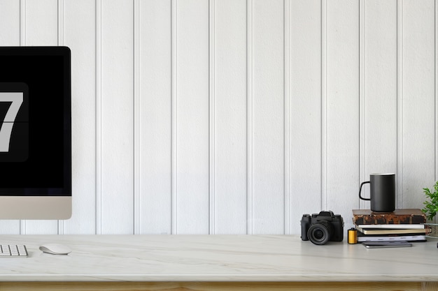 Loft workplace with modern computer and minimal office supplies.