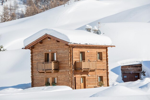 Log cottage nestled in snow