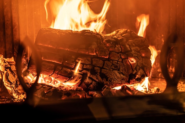 Log of wood burning in a fireplace inside a house hearth