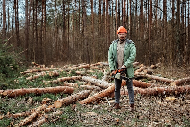 Logging, Worker in a protective suit with a chainsaw