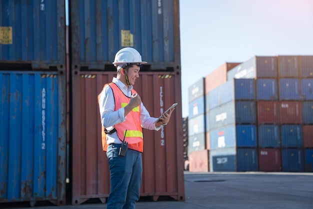 Logistics engineer control at the port, loading containers for trucks  export and importing logistic