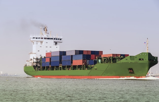 Logistics and transportation Container Cargo ship with tugboat in the ocean