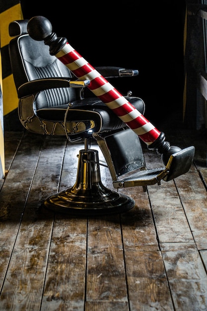 Logo of the barbershop, symbol. Stylish vintage barber chair. Hairstylist in barbershop interior. Barber shop chair. Barbershop armchair, salon, barber shop for men. Barber shop pole.