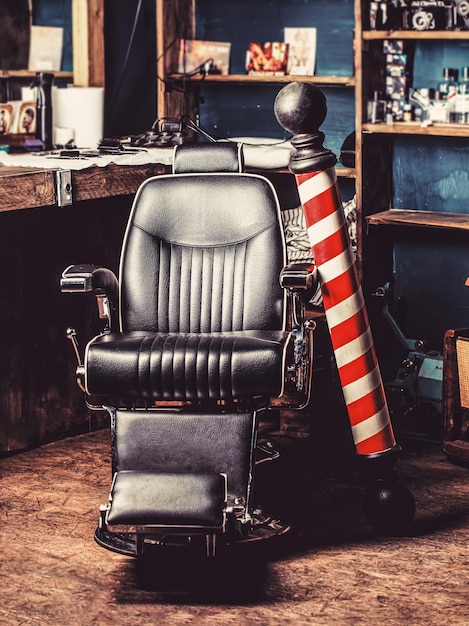 Foto logo van het barbershop-symbool stijlvolle vintage kappersstoel kapper in barbershop interieur kapperszaak stoel barbershop fauteuil salon kapperszaak voor mannen kapper paal