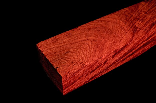 Logs of Burma Padauk wood beautiful pattern for crafts at the black background