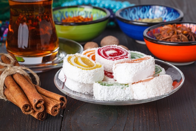 Lokum with tea and traditional sweets on table