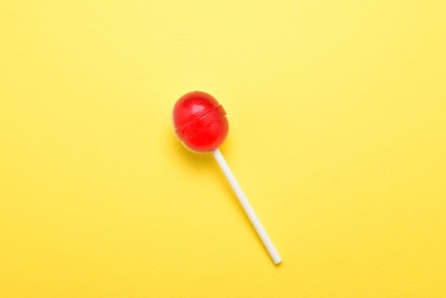 Lollipop on a yellow background. Space for text or design.