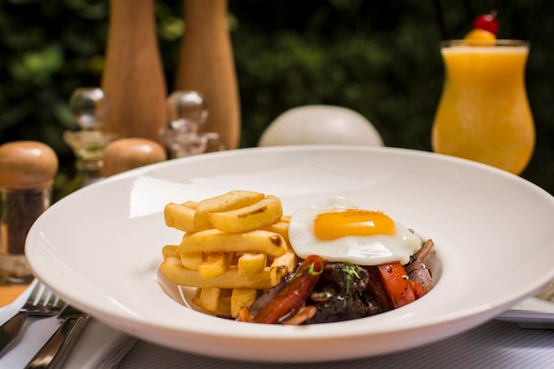 Lomo saltado sauted beef fried egg french fries peruvian gourmet restaurant food