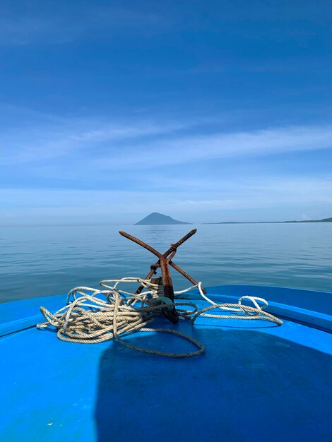 Lone boat in sea against blue sky