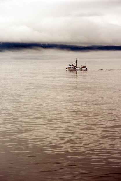 Lone fishing boat motors out strait op weg naar see