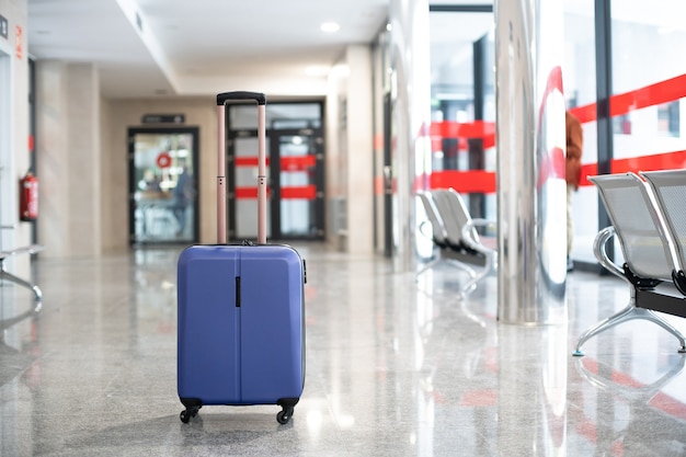 Lonely blue suitcase in the middle of the station