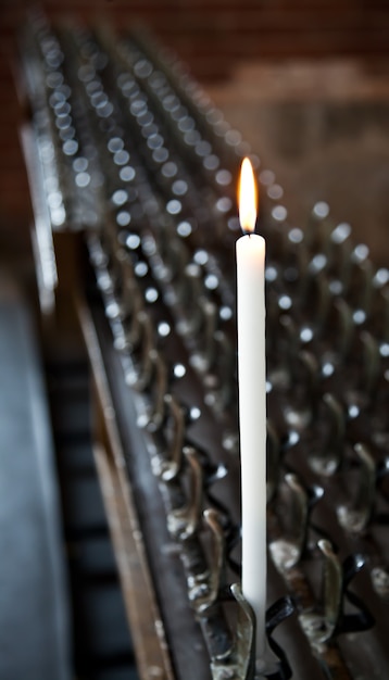 Lonely candle in a Italian Abbey. Concept of hope, faith, loneliness