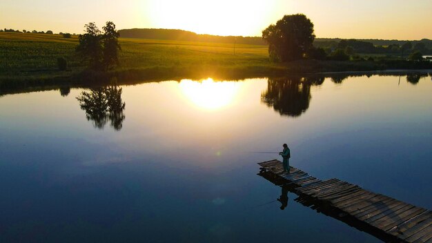 lonely fisherman catches fish in the early morning