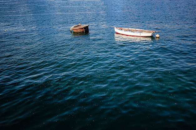 Lonely little boat moored to a buoy in the sea