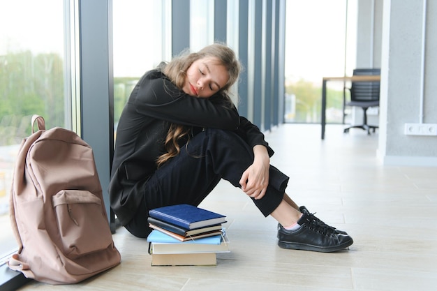 Lonely sad schoolgirl while all her classmates ignored her Social exclusion problem Bullying at school concept